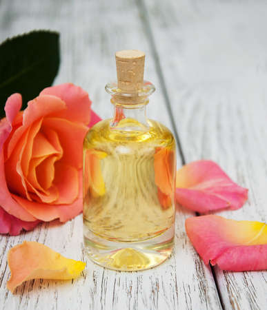 Spa concept with pink roses on a old wooden backgroundの写真素材