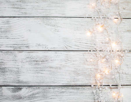 christmas garland lights on wooden rustic backgroundの写真素材