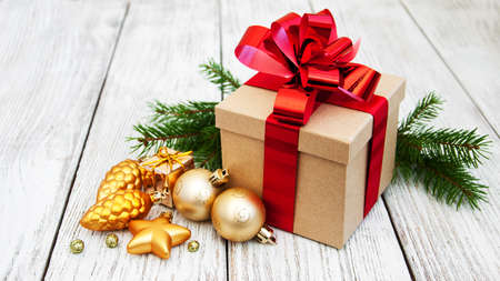 christmas gift box and baubles on a old wooden backgroundの写真素材