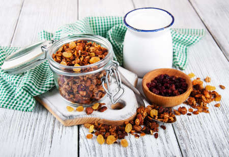 Homemade granola with nuts and milk  on a wooden table