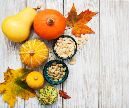 Pumpkins and seed on a old wooden tableの写真素材