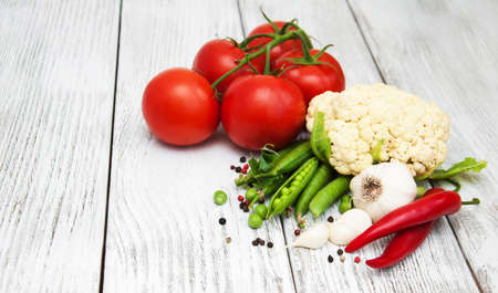 Fresh summer vegetables on a old wooden tableの写真素材