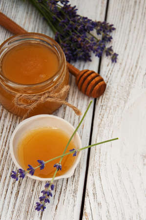 Honey and lavender flowers on a old wooden backgroundの写真素材