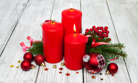 decorative christmas composition with red candles and pineの写真素材