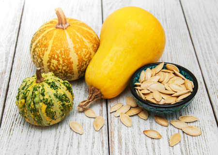 Pumpkins and seed on a old wooden table