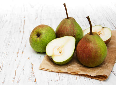 Fresh pears on a old wooden background