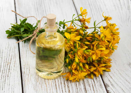 Bottle with St. John's wort extract on the wooden tableの写真素材