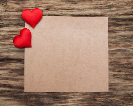 Greeting card with red hearts  on a old wooden backgroundの写真素材