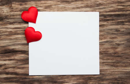 Greeting card with red hearts  on a old wooden backgroundの写真素材