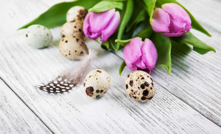 easter background with eggs  and pink tulipsの写真素材