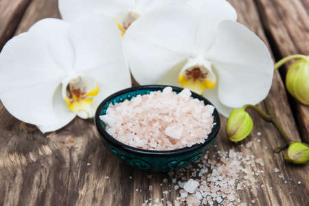 Spa products with white orchids flowers on a tableの写真素材