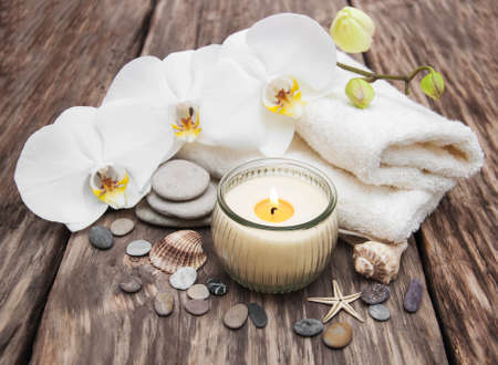 Spa products with white orchids flowers on a tableの写真素材