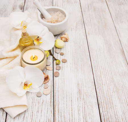 Spa products with white orchids flowers on a tableの写真素材