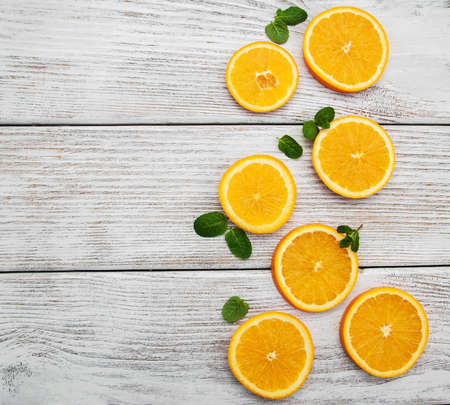 Slices of fresh oranges on a old wooden backgroundの写真素材