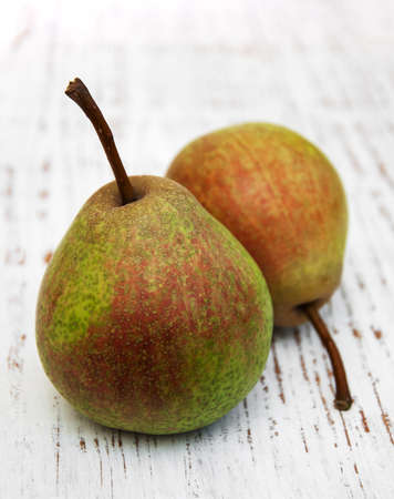 Fresh pears on a old wooden background