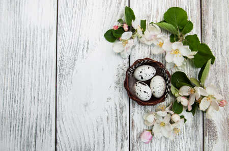 Easter eggs and apple blossom on a old wooden backgroundの写真素材