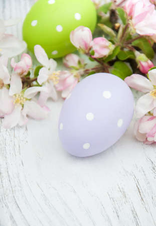 Easter eggs and apple blossom on a old wooden backgroundの写真素材