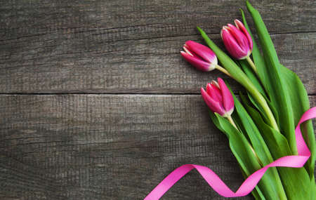 Spring tulips flowers on a old wooden backgroundの写真素材