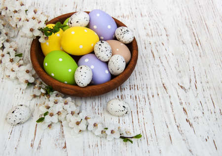 Easter eggs and cherries blossom on a old wooden backgroundの写真素材