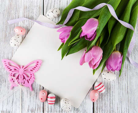 tulip bouquet and blank greeting easter card with eggsの写真素材