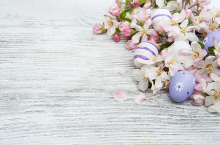 Easter eggs and spring apple blossom on a old wooden backgroundの写真素材