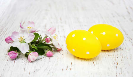 Easter eggs and spring apple blossom on a old wooden backgroundの写真素材