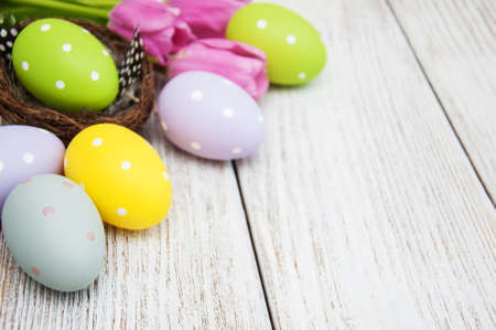 Nest with easter eggs  on a old wooden table