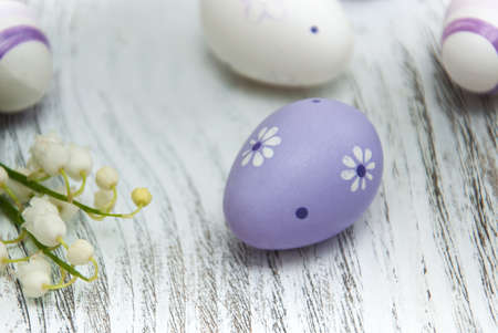 easter eggs with lily of the valley on the wooden table