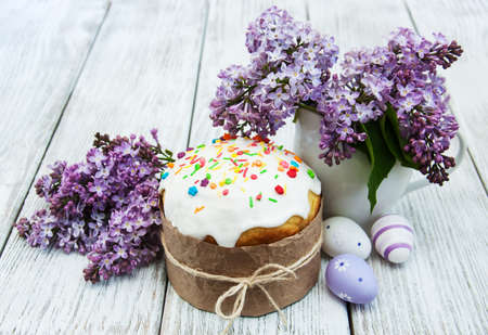 Easter bread and eggs with lilac flowersの写真素材
