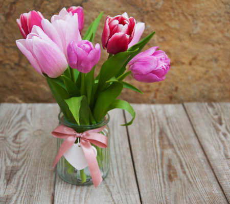 Spring tulips flowers on a old wooden backgroundの写真素材