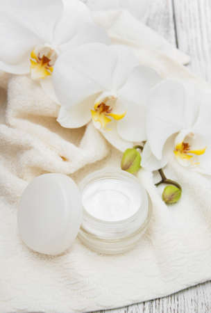 Spa products with white orchids flowers on a tableの写真素材