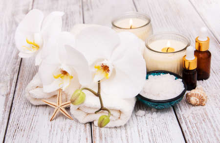 Spa products with white orchids flowers on a tableの写真素材
