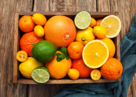 Fresh citrus fruits on a old wooden tableの写真素材