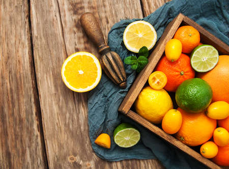 Fresh citrus fruits on a old wooden tableの写真素材