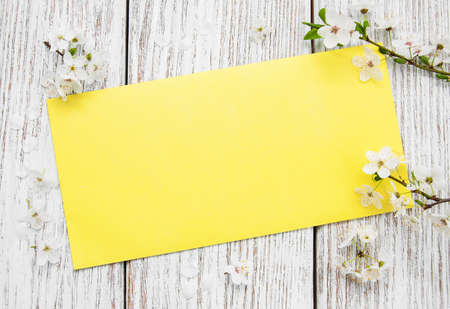 Spring cherries blossom and card  on a old wooden table