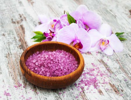 Spa and massage products with orchids on a old wooden backgroundの写真素材