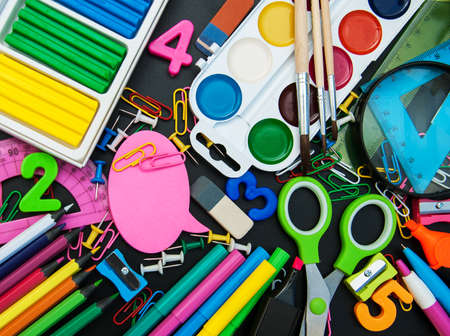 school office supplies  on a chalkboard backgroundの写真素材