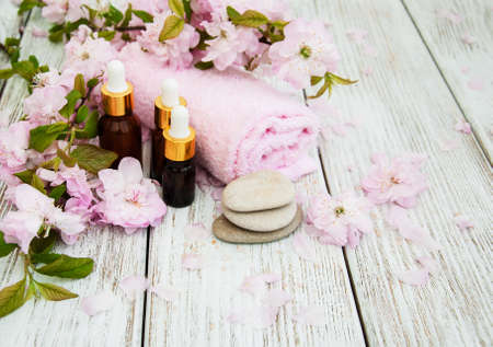 Spa products with sakura blossom on a old wooden tableの写真素材