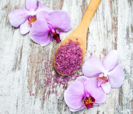 Spa salt and orchids on a old wooden backgroundの写真素材