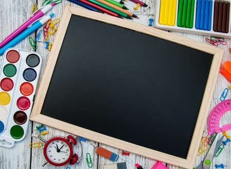 school office supplies  on a chalkboard background