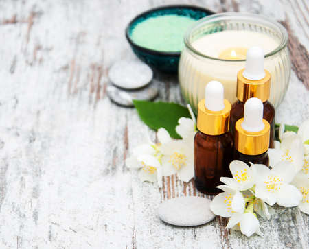 Spa products with jasmine flowers on a wooden tableの写真素材