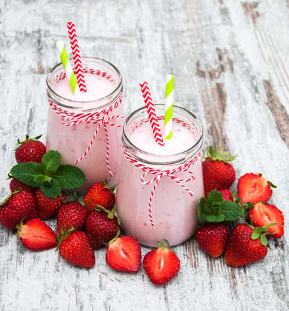 Yogurt  with strawberries on a old wooden tableの写真素材