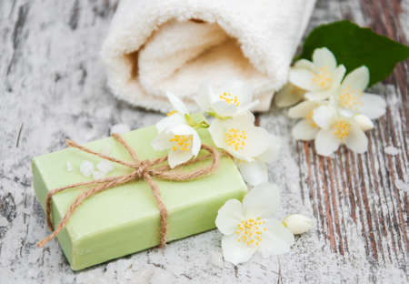Handmade soap and jasmine flowers on a wooden tableの写真素材