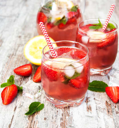 Lemonade with fresh srtawberries,  lemons and iceの写真素材