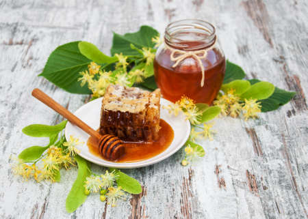 Honey  and linden flowers on a board