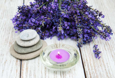 Lavender and massage stones on a old wooden tableの写真素材
