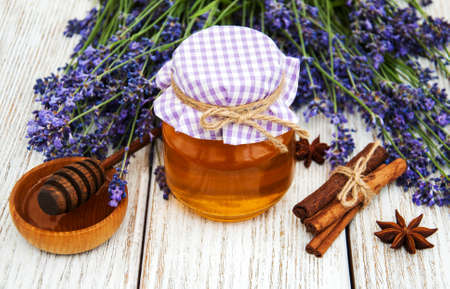 Jars of honey and lavender on a wooden tableの写真素材