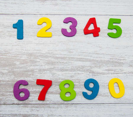 colorful wooden numbers on a old wooden background