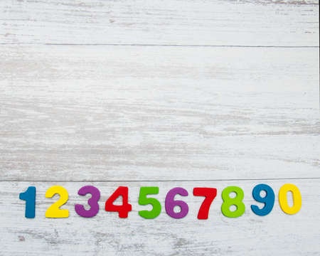 colorful wooden numbers on a old wooden background