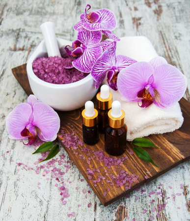 Spa and massage products with orchids on a old wooden backgroundの写真素材